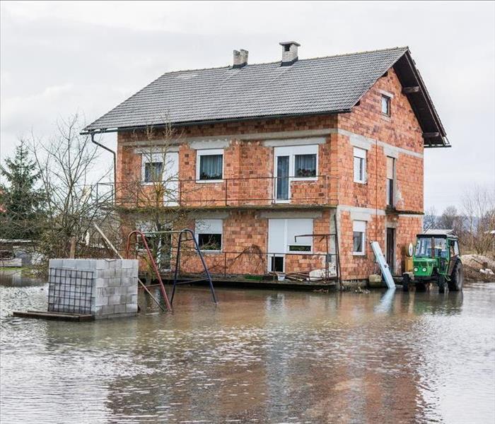 Image of a building surrounded by flooded water in the exterior