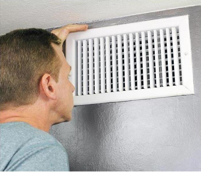 Image of a person changing the air filters