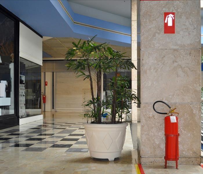 Image of a building's lobby with a fire extinguisher placed properly