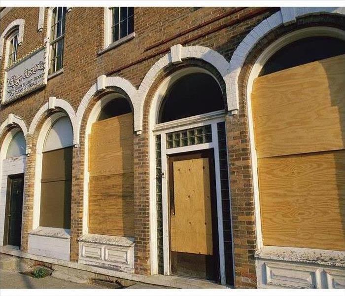 Image of a building with boarded windows. 